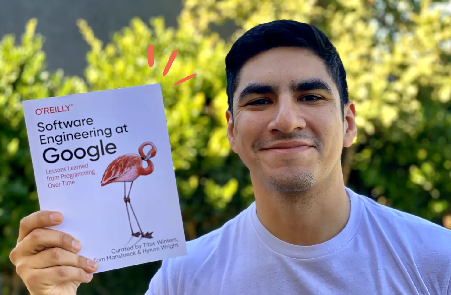 Photo of Maxi holding the book Software Engineering at Google